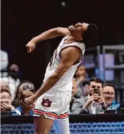  ?? John Bazemore/Associated Press ?? Auburn center Dylan Cardwell dunked home four straight points to help ice Auburn’s semifinal win.
