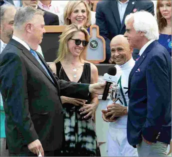  ?? BARBARA D. LIVINGSTON ?? John Asher of Churchill Downs interviews Mike Smith, Bob Baffert, and Tanya Gunther of Glennwood Farm after Justify is paraded before fans on June 16.