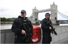  ?? EPA ?? Two armed police officers by Tower Bridge in London