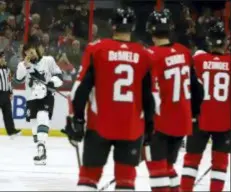  ?? FRED CHARTRAND — THE CANADIAN PRESS VIA AP ?? Ottawa players look on as San Jose’s Erik Karlsson is welcomed onto the ice by fans in Ottawa on Saturday.