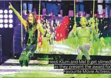  ??  ?? Heidi Klum and Mel B get slimed as they present the award for Favourite Movie Actress.