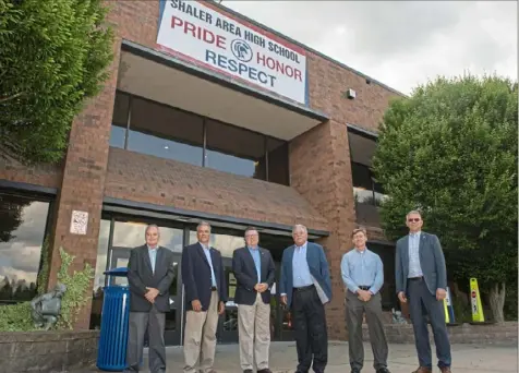  ?? Emily Matthews/Post-Gazette ?? From left, Scott Anderson, manager of Pine Township; Gary Koehler, manager of Fox Chapel; Chris Lochner, manager of Hampton; Tim Rogers, manager of Shaler; Rege Ebner, manager of Franklin Park; and Scot Fodi, manager of Oakmont, stand in front of Shaler Area High School. All of them graduated from Shaler except Mr. Fodi, who grew up in Shaler but graduated from North Catholic High School.