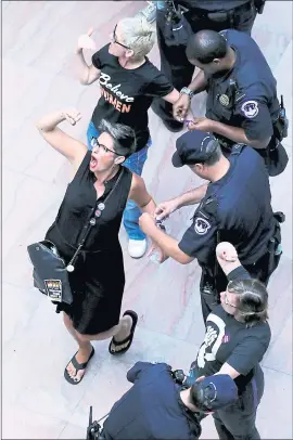  ?? CHIP SOMODEVILL­A — GETTY IMAGES ?? Hundreds of protesters were arrested Thursday by U.S. Capitol Police for demonstrat­ing against the confirmati­on of Supreme Court nominee Judge Brett Kavanaugh in the atrium of the Hart Senate Office Building in Washington, D.C.