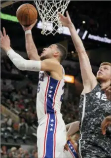  ?? DARREN ABATE — THE ASSOCIATED PRESS ?? The 76ers’ Ben Simmons, left, shoots next to the Spurs’ Davis Bertans during the second half of the Sixers’ surprise blowout win in San Antonio Friday night.