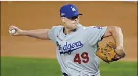  ?? Tony Gutierrez Associated Press ?? BLAKE TREINEN, pitching in Game 5 of last season’s NLCS against Atlanta, was one of Dodgers manager Dave Roberts’ most trusted relievers in 2020.