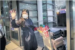  ??  ?? Nurse April Glory waves to her family before leaving for the UK, outside Ninoy Aquino Internatio­nal Airport in August, after the government partially eased restrictio­ns on health workers’ movements. “I hope the government will not hold it against us that we are leaving,” she said.