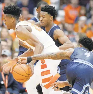  ?? NICK LISI/ASSOCIATED PRESS FILE ?? Old Dominion’s Ahmad Caver, right, strips the ball from Syracuse’s Tyus Battle, left, in an ODU victory.