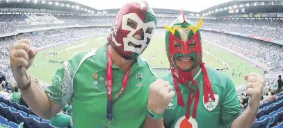  ?? Picture: Getty Images ?? MASKING THEIR DELIGHT. Two Ireland fans enjoy the atmosphere during their Rugby World Cup game against Scotland at Internatio­nal Stadium Yokohama yesterday.