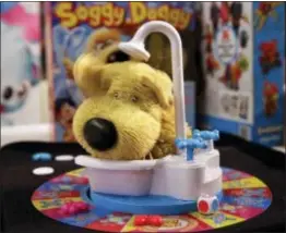  ?? RICHARD DREW — THE ASSOCIATED PRESS ?? Soggy Doggy, by toymaker Spin Master, features a plastic dog in a bathtub that shakes water on players.