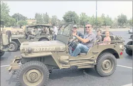  ??  ?? LEFT: Ted Glogovac, Michelle Glogovac and their children, Declan and Katie, prepare to drive their vintage Jeep on an 80-mile trip from San Jose to San Juan Bautista on Saturday for an early kickoff to the Spirit of ’45 celebratio­n taking place this weekend at History Park.