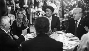  ?? AL DRAGO / THE NEW YORK TIMES ?? President Donald Trump, right, dines with Prime Minister Shinzo Abe of Japan, center; their spouses Melania Trump and Akie Abe; and Robert Kraft, the New England Patriots owner, at the Mar-a-Lago resort Feb. 10 in Palm Beach, Fla. The main way that...