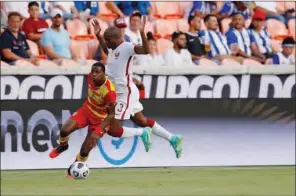  ?? (AFP) ?? Grenada forward Benjamin Ettienne (left) and Qatar defender Abdelkarim Hassan vie for the ball during their CONCACAF Gold Cup match at BBVA Stadium in Houston, Texas, on Saturday.