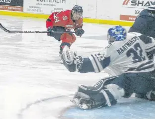  ?? JASON MALLOY ?? Acadia Axemen forward Mason McCarty watches St. F.X. X-Men goalie Joseph Raaymakers make a glove save on his shot during the first period of their Atlantic University Sport hockey game Feb. 19 in Wolfville.