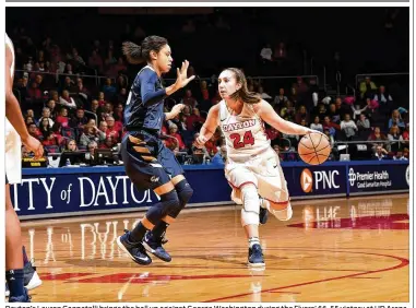  ?? CONTRIBUTE­D BY ERIK SCHELKUN ?? Dayton’s Lauren Cannatelli brings the ball up against George Washington during the Flyers’ 66-55 victory at UD Arena. Cannatelli finished with four 3-pointers in six attempts and 17 points overall.