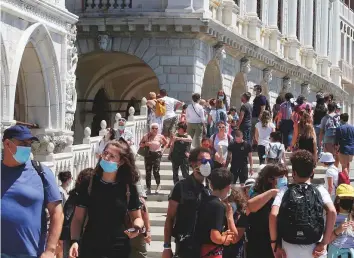  ?? Reuters ?? Tourists are pictured near Saint Mark’s Square, amid the coronaviru­s disease outbreak, in Venice, Italy. Hospitals are preparing for the next wave of infections.