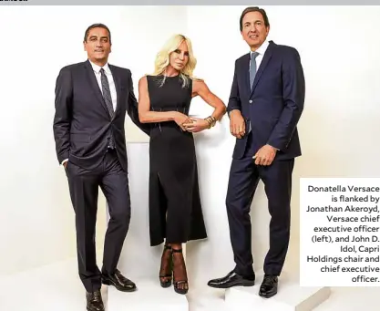  ??  ?? Donatella Versace is flanked by Jonathan Akeroyd, Versace chief executive officer (left), and John D. Idol, Capri Holdings chair and chief executive officer.