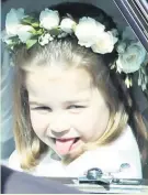  ??  ?? Princess Charlotte sticks out her tongue as she rides to the wedding