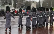  ?? — AFP ?? Members of the Queen’s Guard march towards the Buckingham Palace on Monday.