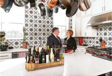  ??  ?? Restaurant­eur Bill Floyd and his wife, Charlene, are proud owners of a four-story chateau built by Toll Brothers and customized to include custom tilework, a wine room, and a fourth-floor fireplace by which to enjoy their view of the downtown skyline.