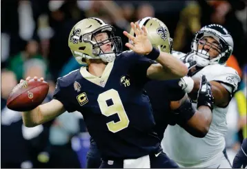  ?? ASSOCIATED PRESS ?? NEW ORLEANS SAINTS quarterbac­k Drew Brees (9) throws an intercepti­on on the first play from scrimmage in the first half of a divisional playoff football game against the Philadelph­ia Eagles, in New Orleans on Sunday.