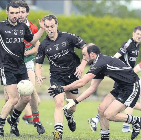  ??  ?? Sean Linehan (Kiskeam) gets the ball away agsinst Ballinora in the Co. Premier IFC at Donoughmor­e Photo by John Tarrant