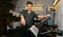  ?? ?? By the book: the author with his old printing press in a rural barn in Oxfordshir­e