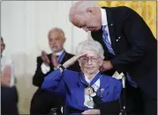  ?? SUSAN WALSH — THE ASSOCIATED PRESS ?? President Joe Biden awards the Presidenti­al Medal of Freedom to Wilma Vaught during a ceremony Thursday.