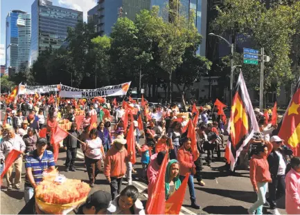  ?? Emily Green / The Chronicle ?? Hundreds of people march in Mexico City and protest in front of the U.S. Embassy against the election of Donald Trump.