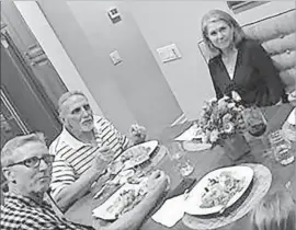  ??  ?? CRAIG COLEY, second from left, spent Thanksgivi­ng with Mike Bender, the retired detective who helped free him. After dinner, they walked to the beach.