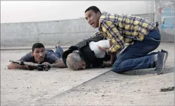  ?? PICTURE: AP ?? Egyptian security forces help Giza police chief General Nabil Farag, centre, who was shot by unidentifi­ed militants. The militants opened fire on security forces deployed to the town of Kerdasa to drive off suspected Islamists taking control of the...