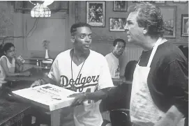  ?? COURTESY OF UNIVERSAL CITY STUDIOS ?? Danny Aiello as Salvatore “Sal” Fragione, right, speaks to Spike Lee as Mookie in “Do the Right Thing.”