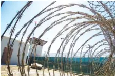  ?? AP FILE PHOTO/ALEX BRANDON ?? The control tower is seen through the razor wire inside the Camp VI detention facility in Guantanamo Bay Naval Base, Cuba.