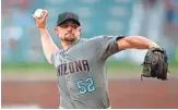  ?? TODD KIRKLAND/GETTY IMAGES ?? Diamondbac­ks pitcher Zack Godley picks up his 11th win of the season, and Arizona wins the opening game of this weekend’s series against the Atlanta Braves by a score of 2-1.