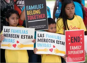  ?? AP PHOTO BY WILFREDO LEE ?? Children hold signs June 1 during a demonstrat­ion in front of the Immigratio­n and Customs Enforcemen­t offices in Miramar, Fla. The Trump administra­tion’s move to separate immigrant parents from their children on the U.s.-mexico border has turned into a...