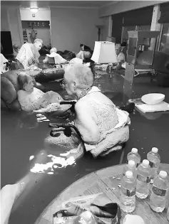  ??  ?? File photo showing residents of La Vita Bella assisted living facility in waist-deep flood water due to Tropical Storm Harvey in Dickinson, Texas. — Reuters photo