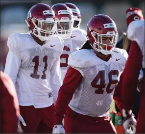  ?? NWA Democrat-Gazette/ANDY SHUPE ?? Arkansas freshman defensive end Mataio Soli (11), here participat­ing in a spring drill in March, said the chance to play early factored in his decision to choose the Razorbacks.