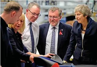  ??  ?? Economic benefit: Theresa May and David Mundell at Scottish Fine Leather