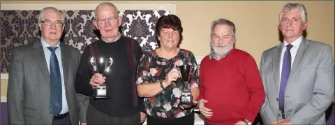  ??  ?? Brian Warren and Hugh Callaghan of Dunleer Tidy Towns present Paul and Helen Corrigan and Ben Matthews with joint second prize in the small garden category.