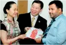  ??  ?? Song Jianhua, Chairman of Sino-sri Lanka Rich Investment and the leader of Chinese Investment Delegation to Sri Lanka presenting her firm’s investment profile to Minister Rishad Bathiudeen