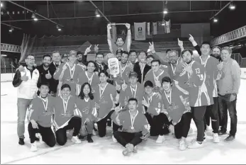  ?? XINHUA ?? Team China players and officials celebrate after defeating Spain 4-1 to win the Division II Group A title at the 2022 IIHF Men’s World Championsh­ip in Zagreb, Croatia, on April 30. The triumph secured China a spot in Division I Group B after an absence of 15 years.