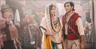  ?? Associated Press photo ?? This image released by Disney shows Naomi Scott as Jasmine and Mena Massoud as Aladdin, right, in Disney's live-action adaptation of the 1992 animated classic “Aladdin.”