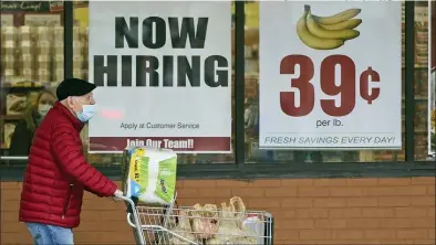  ?? TONY DEJAK — THE ASSOCIATED PRESS FILE ?? A shopper outside a Marc’s Store last week in Mayfield Heights, Ohio. Fewer Americans applied for unemployme­nt benefits last week, lowering claims to 900,000, still a historical­ly high level that points to further job cuts in a raging pandemic.