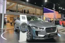  ?? ZHANG DANDAN / CHINA DAILY ?? Jaguar showcases its electric model I-Pace with its charging pole at the 2018 Guangzhou auto show.