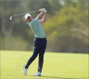  ?? Kamran Jebreili / Associated Press ?? Rory McIlroy plays a shot on the 13th fairway during Saturday’s third round of the Dubai Desert Classic in Dubai, United Arab Emirates.