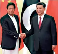  ?? AFP ?? China’s President Xi Jinping shakes hands with Prime Minister Imran Khan before their meeting in Beijing on Sunday. —