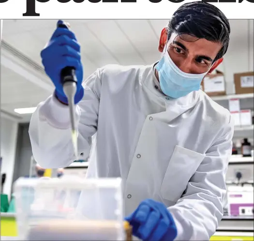  ??  ?? UPBEAT: Chancellor Rishi Sunak witnesses the work being done in the fight against Covid in a London laboratory last month – and lends a hand