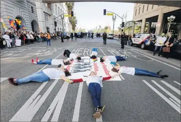  ?? Irfan Khan Los Angeles Times ?? POLICE ARRESTED seven protesters who blocked traffic and refused to leave after a dispersal order, an officer said. The activists say L.A.’s street vending proposal favors brick-and-mortar businesses over vendors.