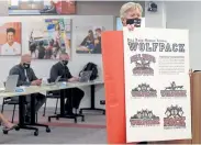  ?? Jenny Sparks, Loveland Reporter- Herald ?? Bill Reed Middle School Principal Arnold Jahnke unveils a rendering of the school’s new mascot, the Wolfpack, on Wednesday during a Thompson School Board meetings.