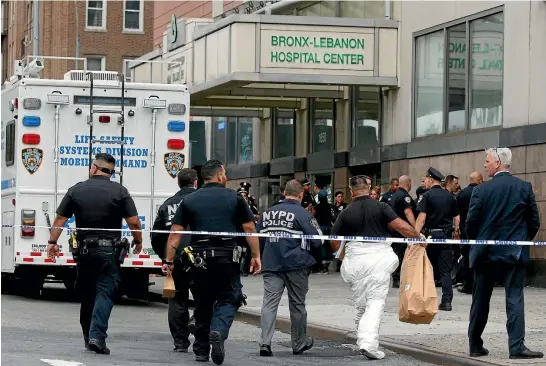  ?? REUTERS ?? NYPD crime scene investigat­ors arrive at Bronx-Lebanon Hospital after a doctor who used to work there opened fire with an assault rifle he had concealed under a lab coat, killing a woman and leaving several doctors seriously wounded, before shooting...