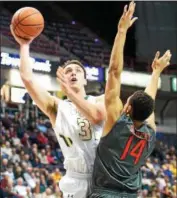  ?? PHOTO PROVIDED BY SIENA ATHLETICS ?? Siena’s Brett Bisping, left, shoots over Fairfield’s Marcus Gilbert during a game at the TU Center in Albany. Bisping signed his first profession­al contract with Boras Basket in Sweden.